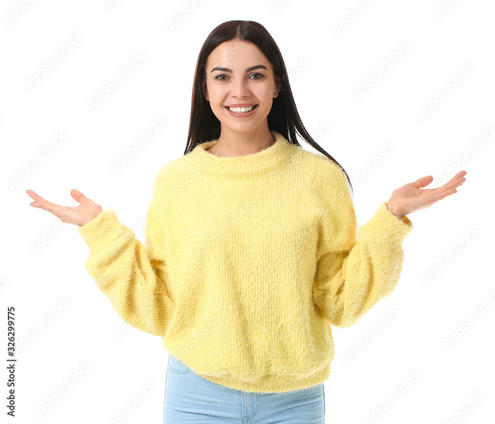 Beautiful young woman in warm sweater on white background