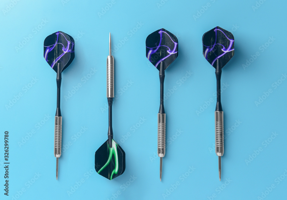 Darts on color background, top view