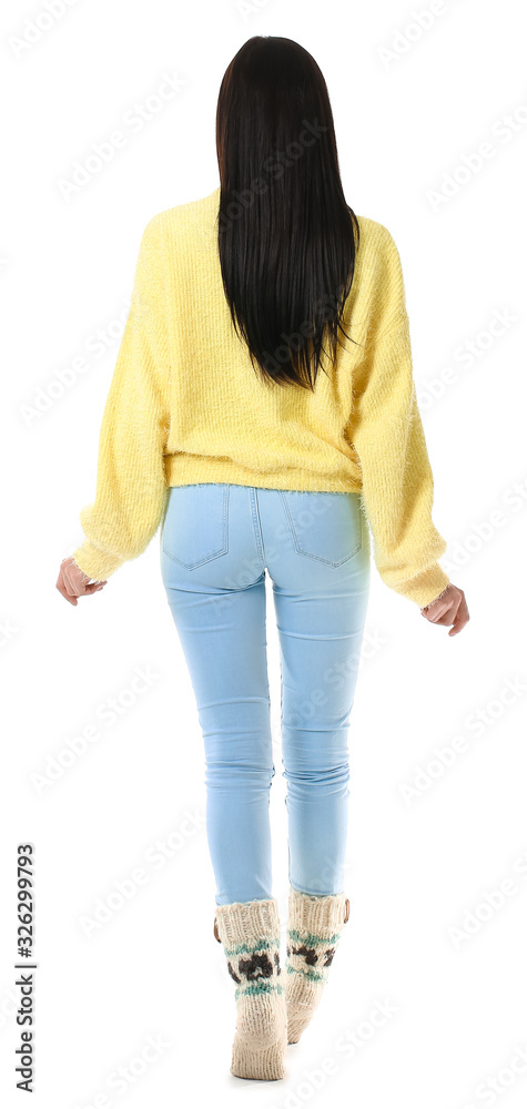 Beautiful young woman in warm sweater on white background, back view