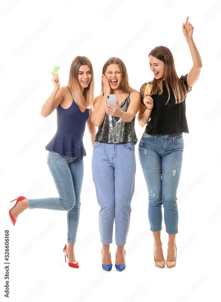 Young women with mobile phone and credit cards on white background. Online shopping concept