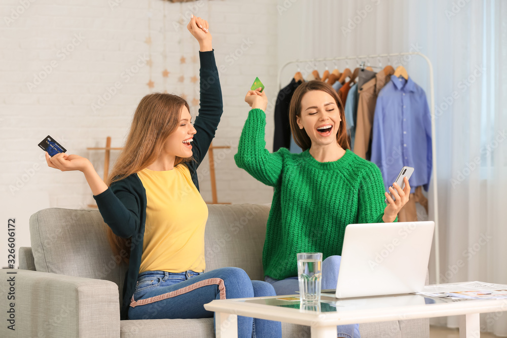 Young women using laptop for online shopping at home