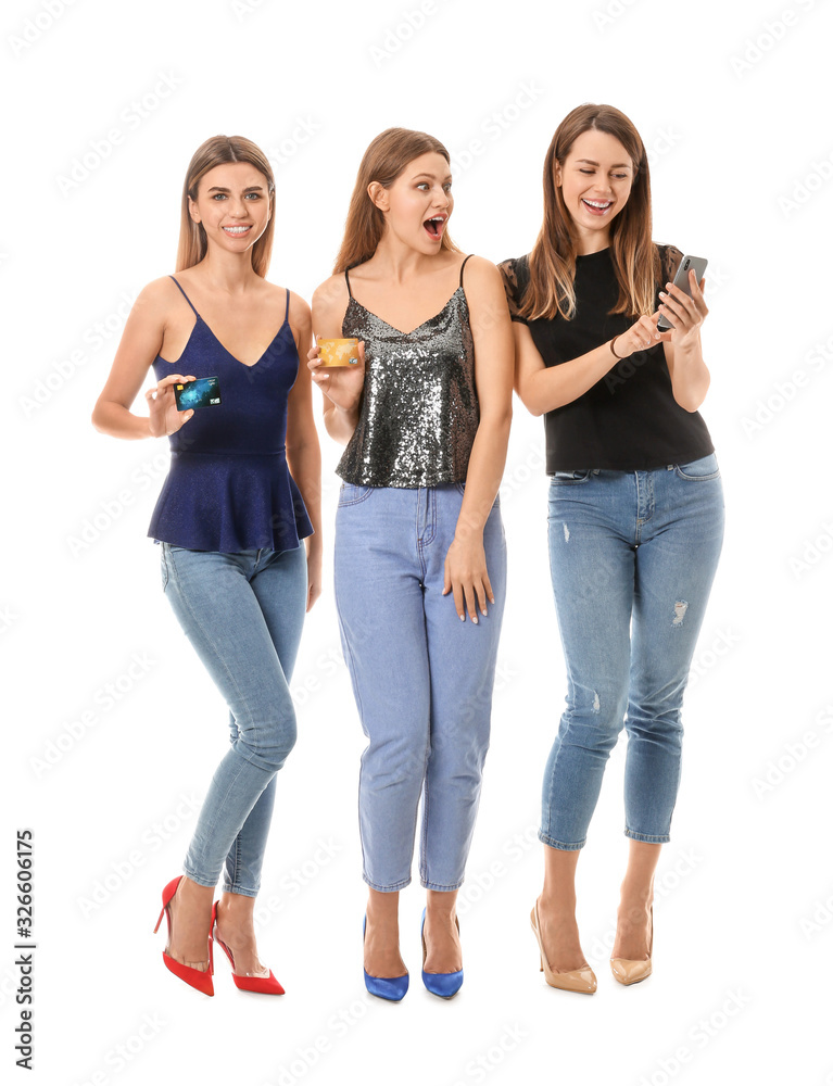 Young women with mobile phone and credit cards on white background. Online shopping concept