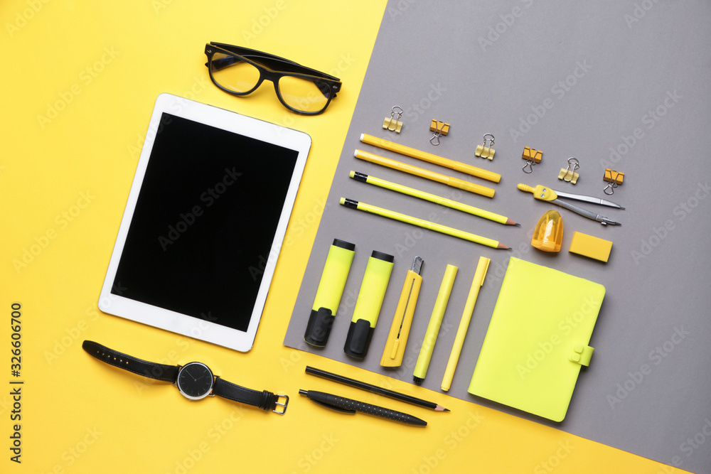 Set of school supplies with tablet computer on color background