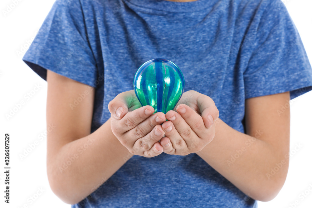 Little child with light bulb on white background, closeup. Earth Day celebration