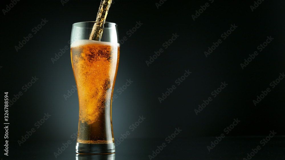 Freeze motion of pouring beer into glass pint