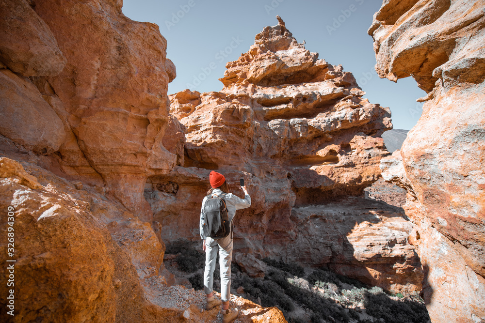 女性旅行者站在火山起源的巨石之间欣赏美丽的风景