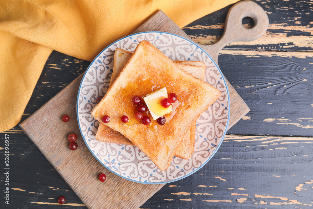 Tasty toasted bread with honey, butter and berries on plate