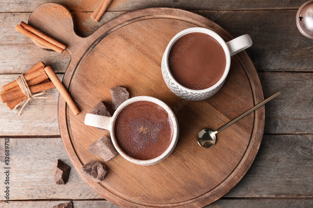 Cups of hot chocolate on wooden table