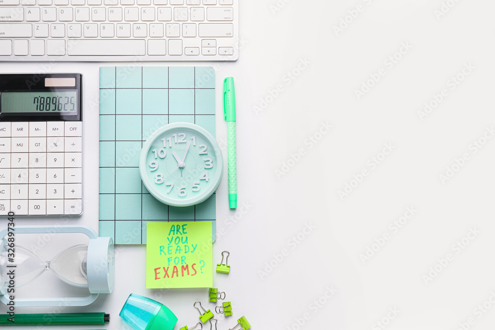 Stationery, computer keyboard and paper sheet with text ARE YOU READY FOR EXAMS? on white background