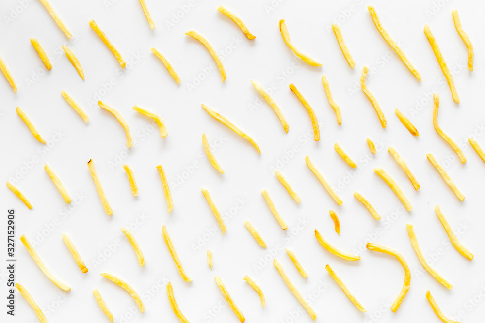 French fries background on white table top-down pattern