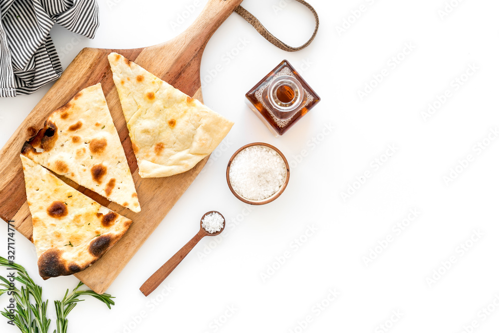 Italian focaccia with cheese and rosemary on white background top-down copy space