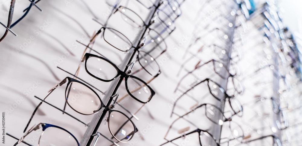 Glasses on display on wall in store. Showcase with spectacles in modern ophthalmic store.