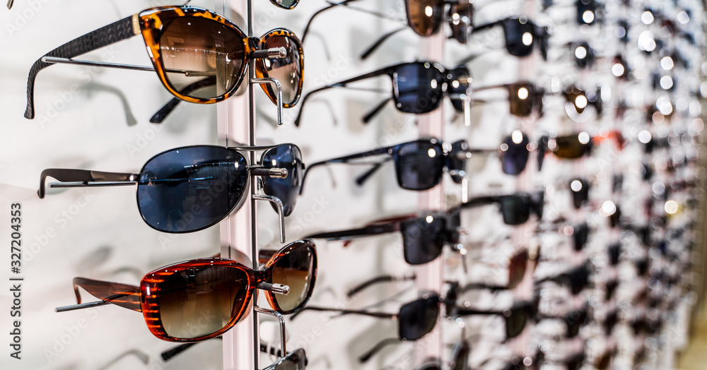 Sunglasses on display shelves in glasses store