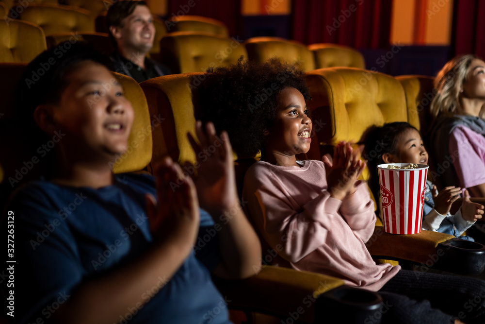 People audience watching movie in the movie theater cinema. Group recreation activity and entertainm