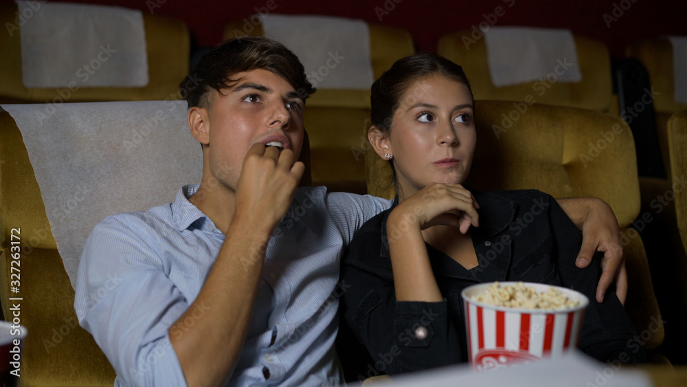 People audience watching movie in the movie theater cinema. Group recreation activity and entertainm