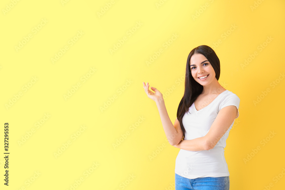 Beautiful young woman on color background