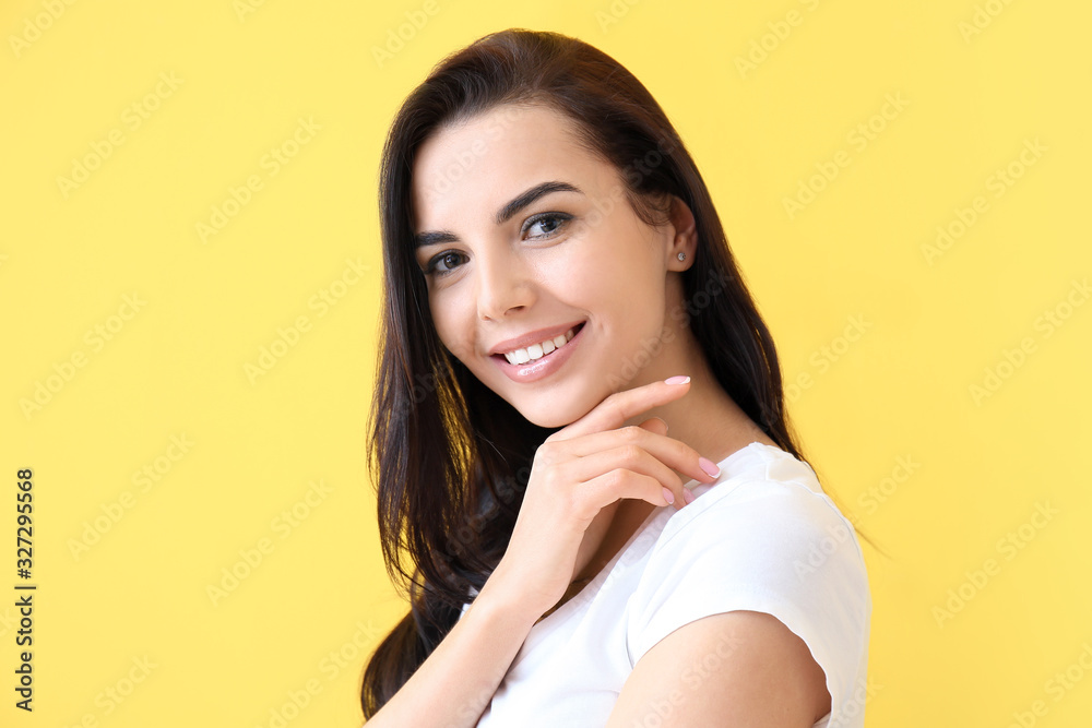 Beautiful young woman on color background