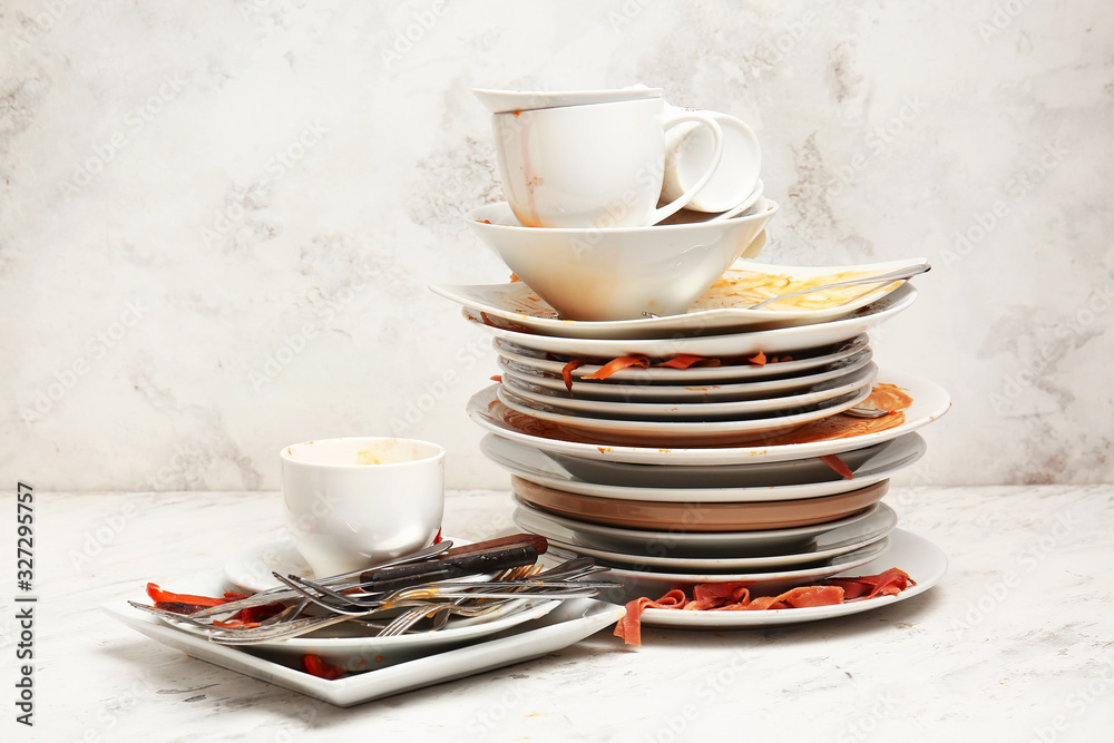 Dirty tableware on light background