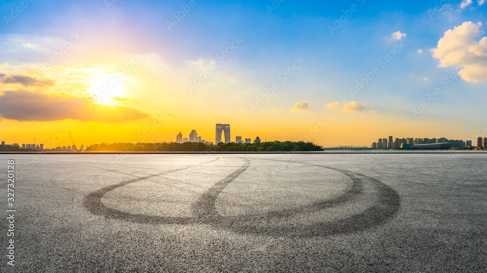 Empty race track and beautiful city skyline with buildings at sunset in Suzhou,panoramic view.