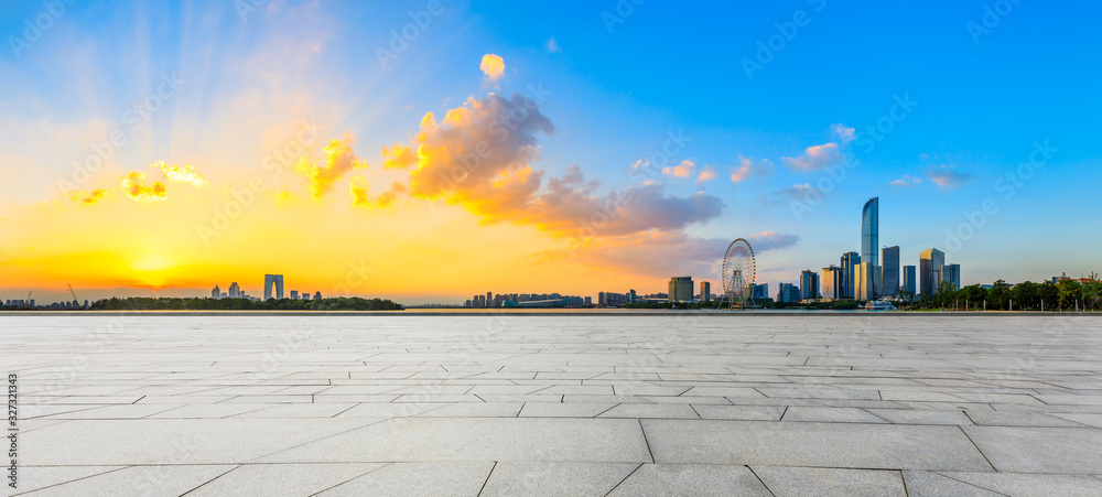 Empty square floor and beautiful city skyline with buildings at sunset in Suzhou,panoramic view.