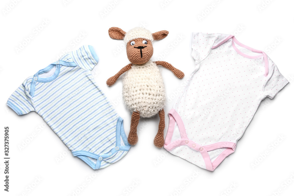 Baby clothes with toy on white background