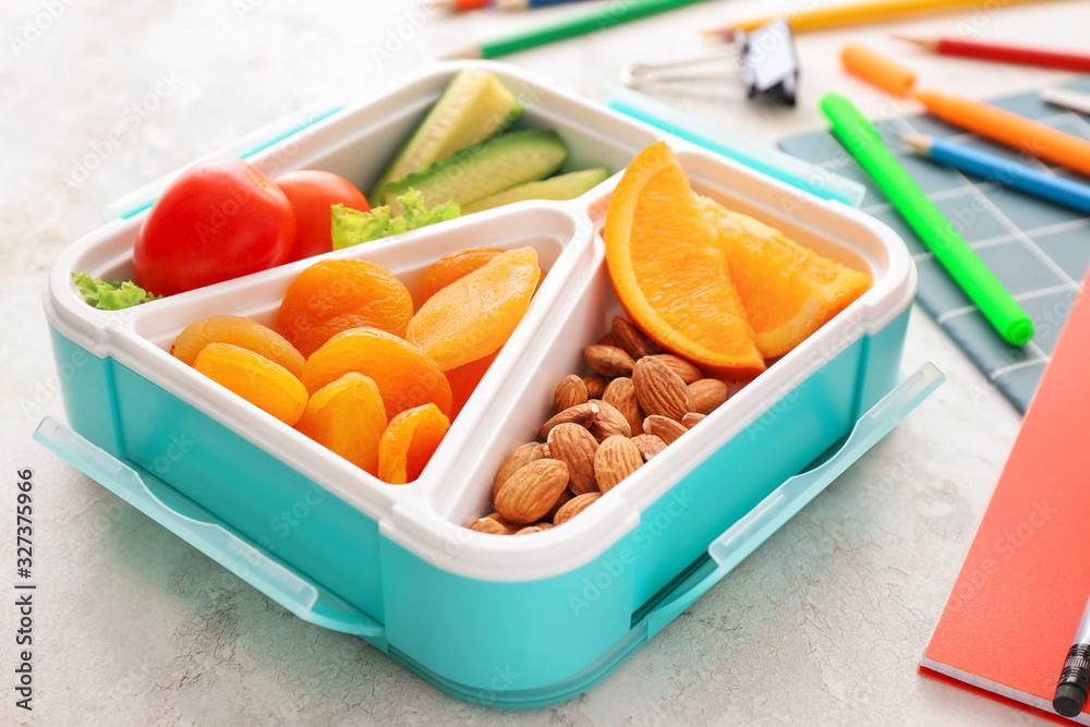 School lunch box with tasty food on table