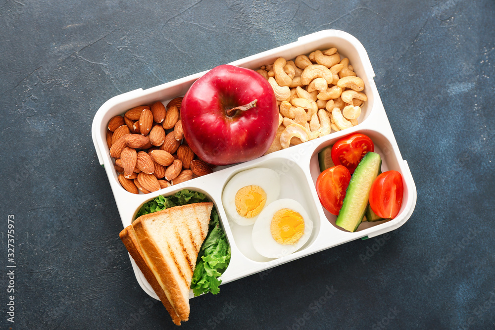 School lunch box with tasty food on table