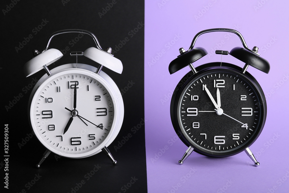 Alarm clocks on color background. Time management concept