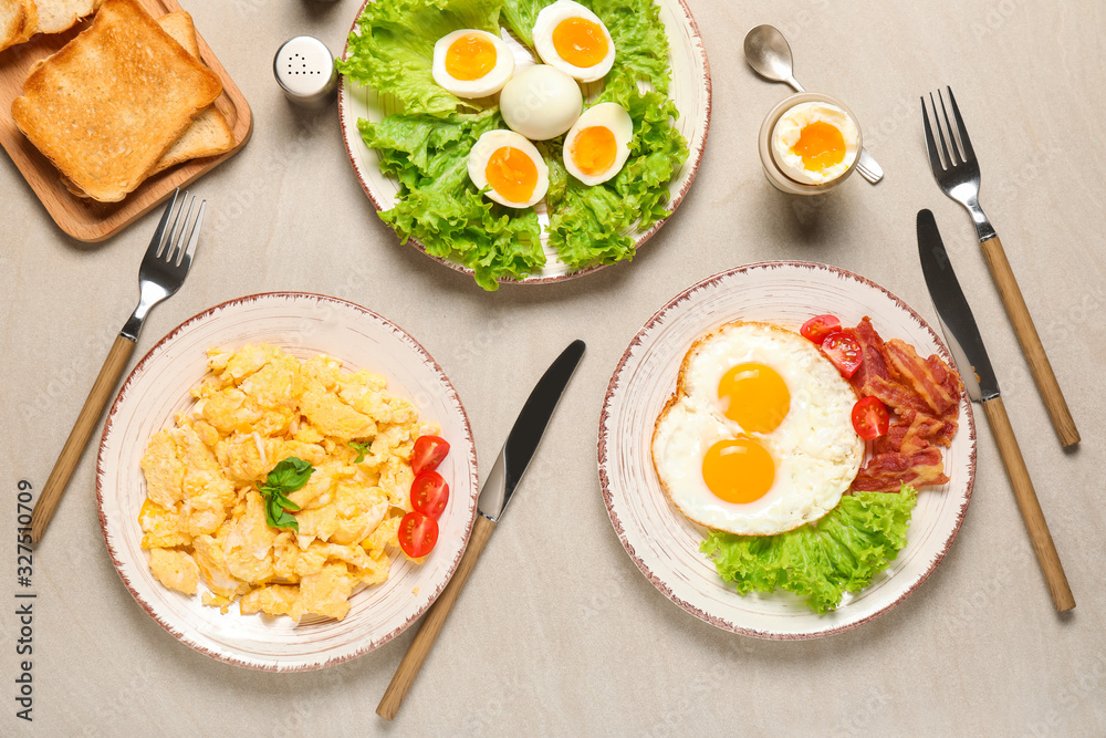 Different tasty dishes with eggs on table