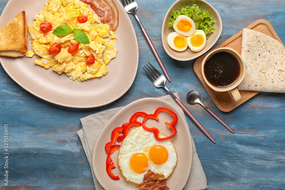 Different tasty dishes with eggs and coffee on table