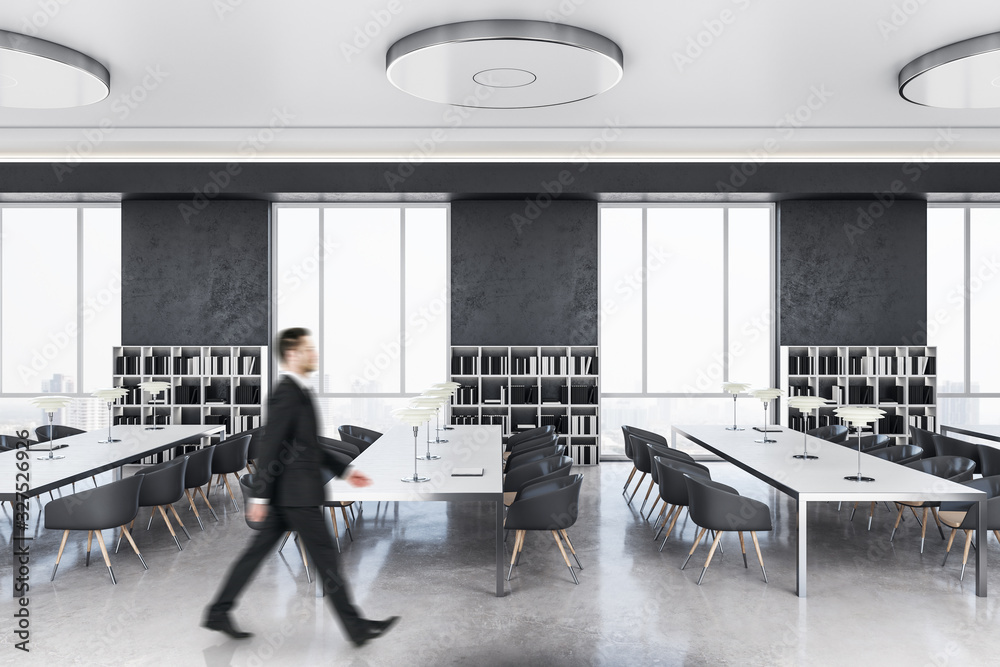 Businessman walking in modern library interior