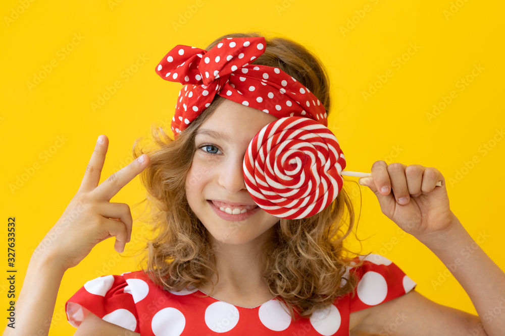 Teenager girl holding red lollipop