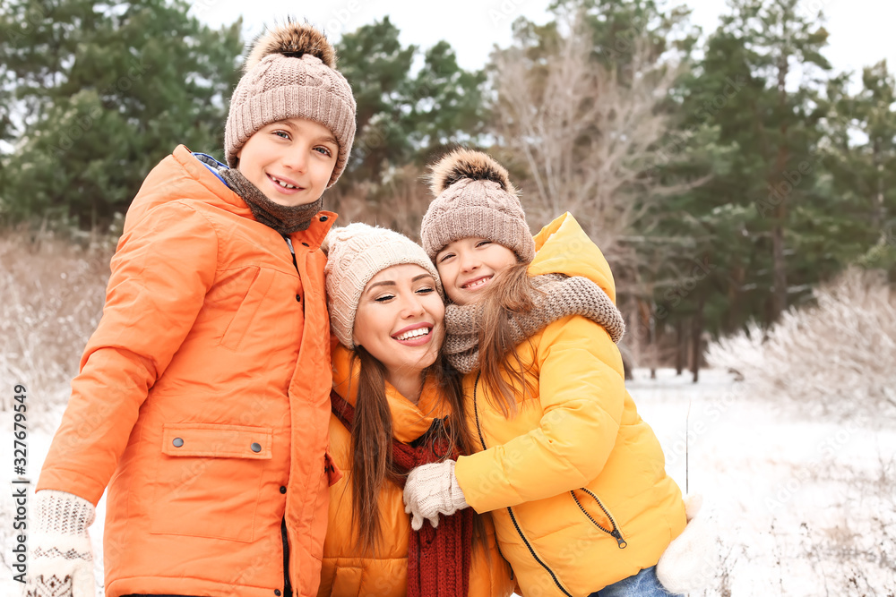 Mother with little children in park on winter day