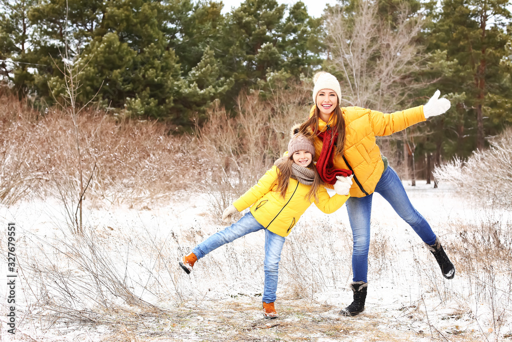 Mother with little daughter in park on winter day