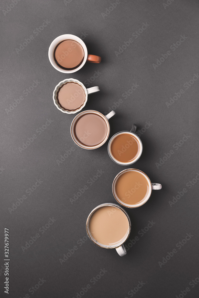 Cups of different coffee on dark background