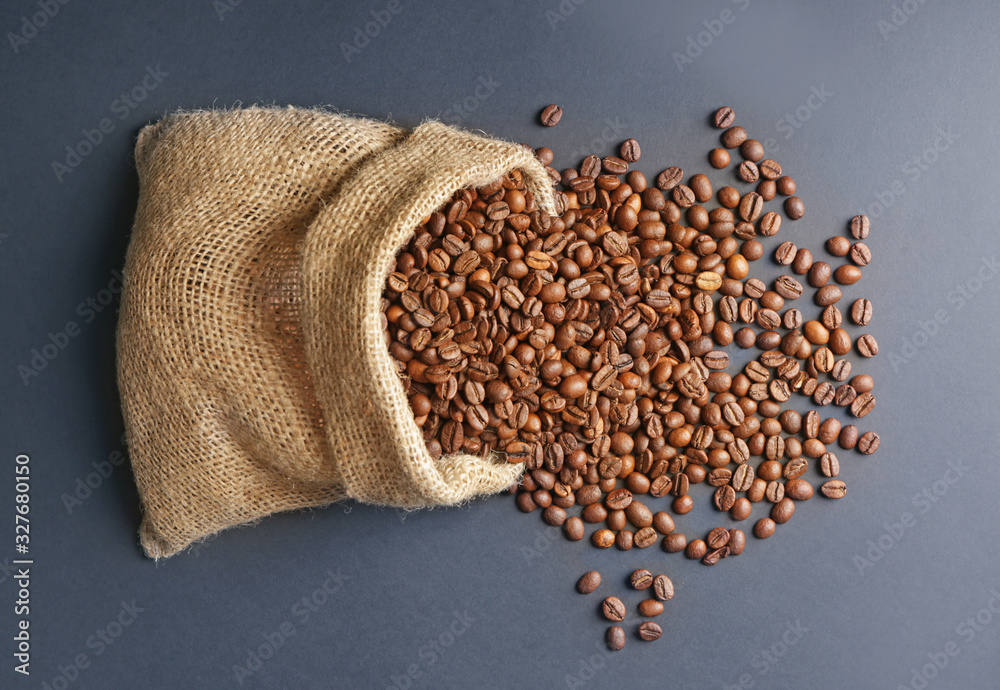 Bag with coffee beans on dark background