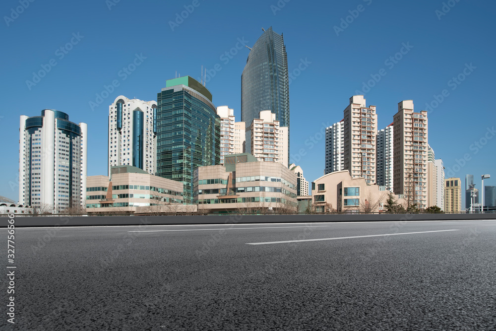 Qingdao urban skyline and asphalt road architectural landscape..