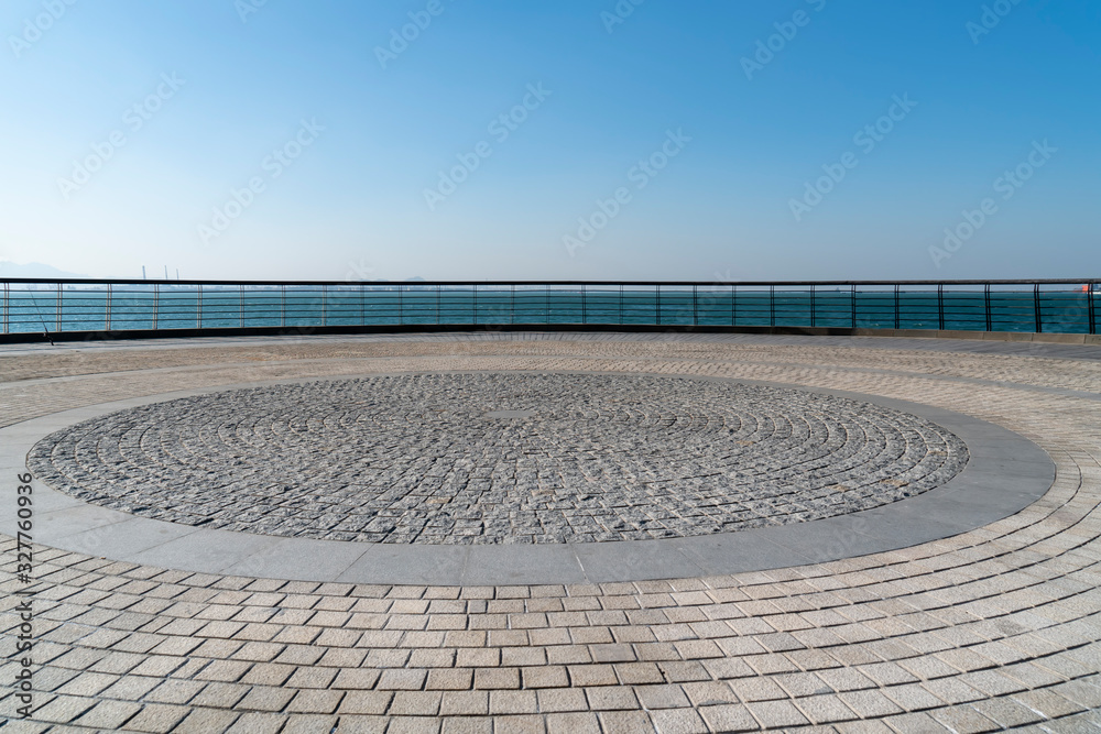 Floor tiles and seascape of city square..