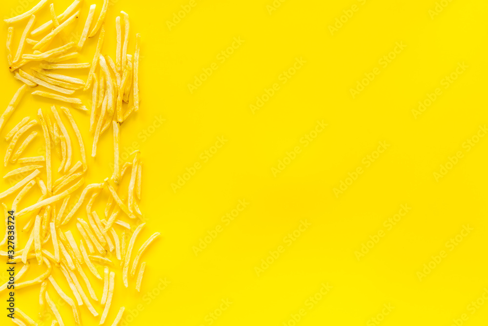 French fries frame on yellow table top-down copy space