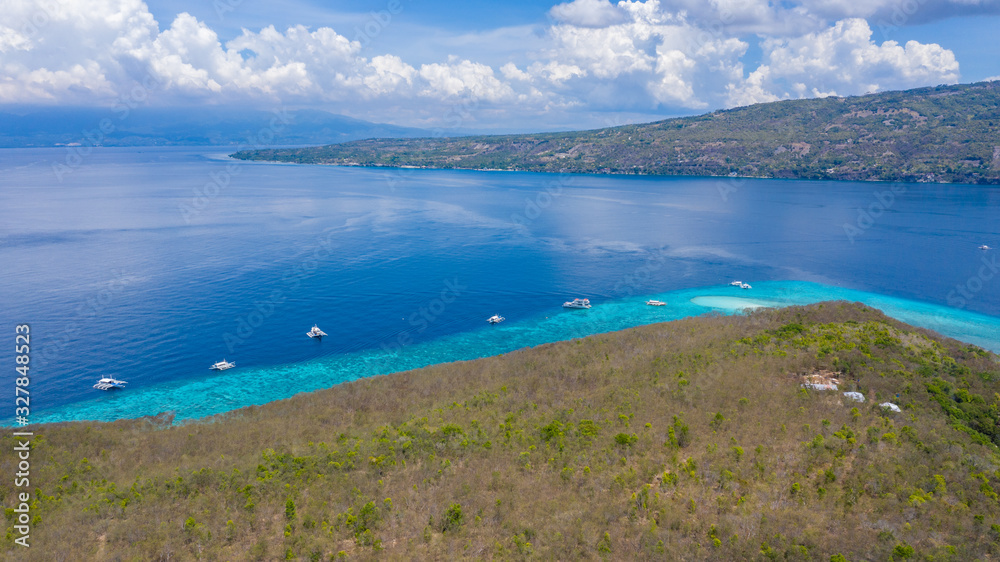 Aerial view of the Sumilon island, sandy beach with tourists swimming in beautiful clear sea water o