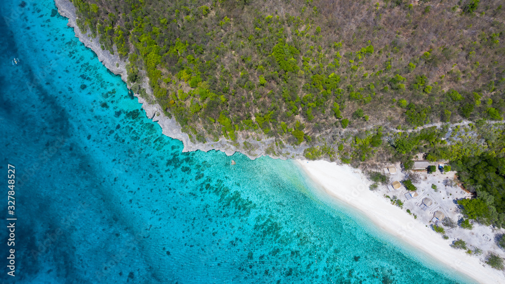 Aerial view of the Sumilon island, sandy beach with tourists swimming in beautiful clear sea water o