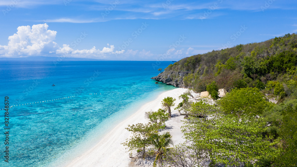 Aerial view of the Sumilon island, sandy beach with tourists swimming in beautiful clear sea water o