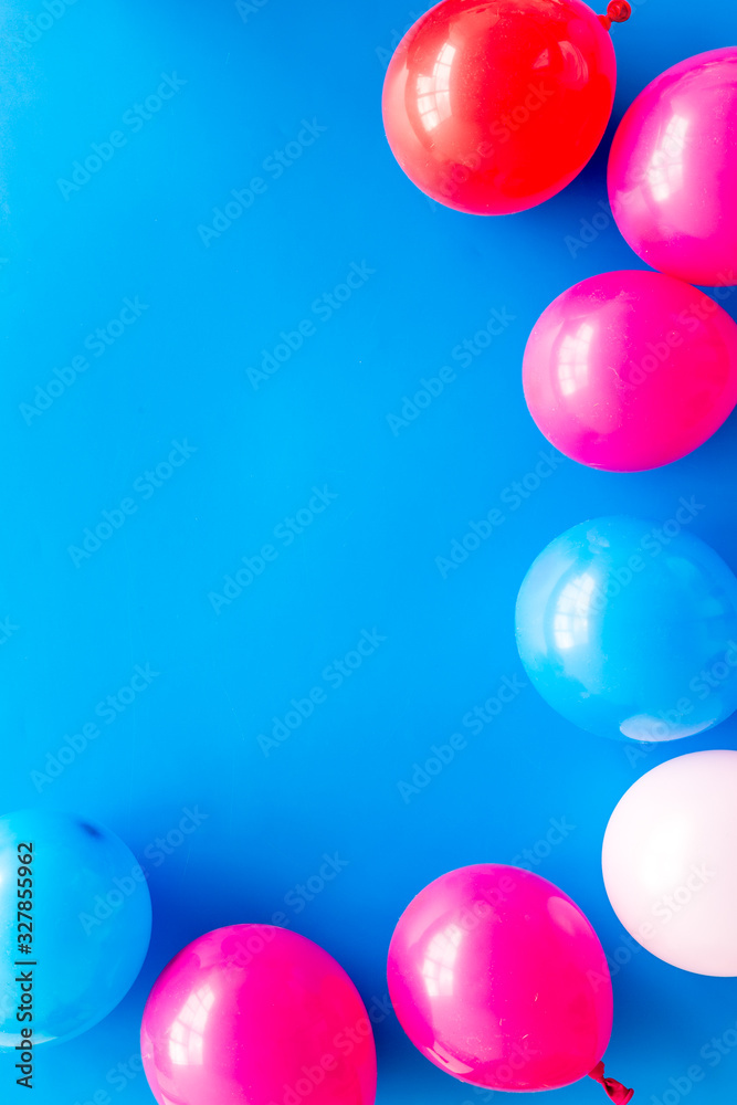 Decorative frame with colorful balloons on blue background top-down frame copy space