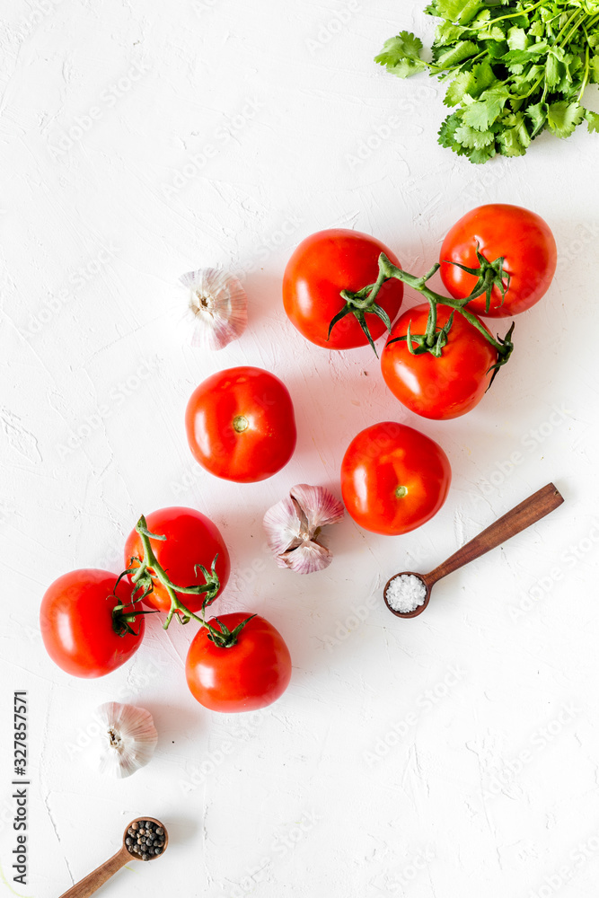 Tomatoes for preserves. Vegetables near garlic, greenery and spices on white background top-down cop