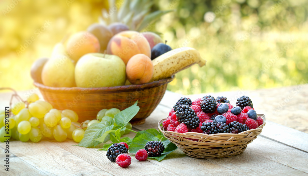 Forest fruit, forest berries in basket on wooden table