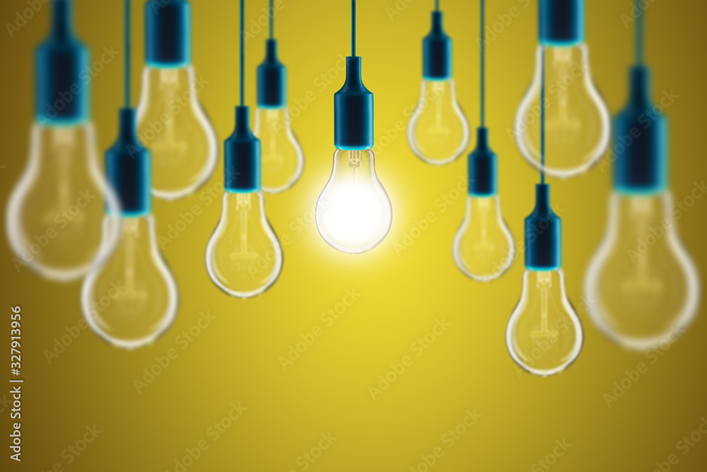 Idea and leadership concept - bulbs on the yellow background