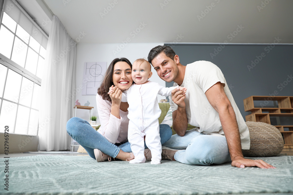 Cute baby with parents at home