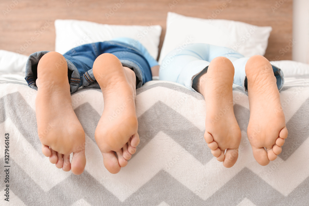 Young couple lying on bed at home