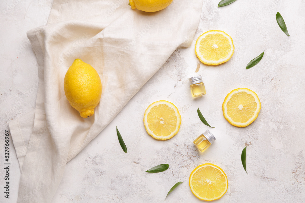 Composition with lemon essential oil on light background