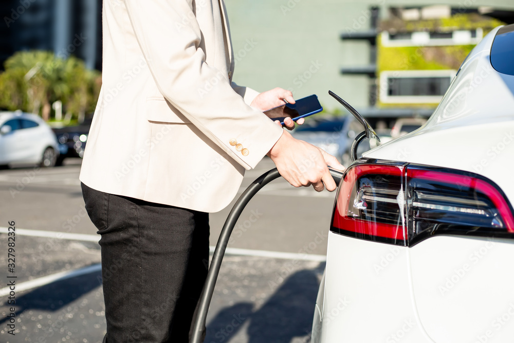 man Charges electric car